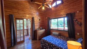 a bedroom with a bed and a ceiling fan at Mahanaim Casa De Campo in Caaguazú +100 photos