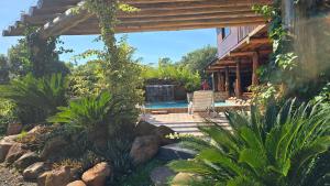 a house with a patio and a swimming pool at Mahanaim Casa De Campo in Caaguazú