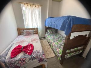 a bedroom with two beds and a bed with a bow at Apartamentos Brisas de la Rivera in Monterrey