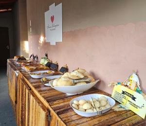 a buffet line with bowls of bread and pastries at Pousada Ame Jalapão in Mateiros