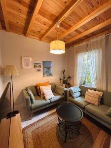 a living room with two couches and a table at Casa Casco Antiguo A Guarda in A Guarda