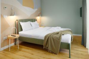 a bedroom with a large bed with a blanket on it at Yellow - 3 Bedroom House with Private Garden, 10 mins driving from Old Town in Braşov