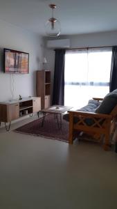 a living room with a couch and a coffee table at Blue House in San Nicolás de los Arroyos
