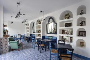 a dining room with tables and chairs and a wall with mirrors at Hotel Mignon Meublè in Sorrento