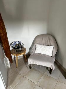 a chair sitting in a corner with a table at LES TERRASSES (centre de Pierrefonds) in Pierrefonds +16 photos