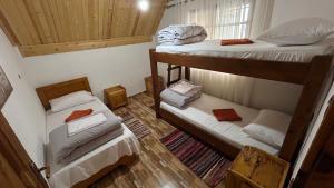 a room with two bunk beds in a house at Guesthouse Lola in Valbonë