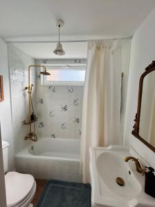 a bathroom with a tub and a toilet and a sink at La Casita de las Vistas in A Guarda