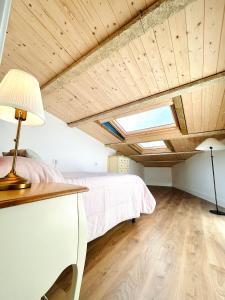 a bedroom with a bed and a desk and a skylight at La Casita de las Vistas in A Guarda