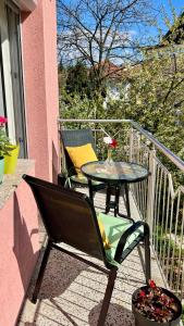 a patio table and chairs on a balcony at Guest House Bosnian House in Sarajevo