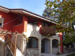 a house with two balconies on the side of it at La Valeriana Farm Apartments in San Daniele del Friuli