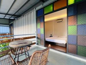 a balcony with a table and chairs and a bed at River Janggut in Jeram