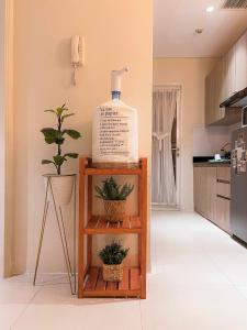 a bottle of water sitting on a shelf in a kitchen at Madison Park Apartment HOMEY by Host Jess in Jakarta +57 photos