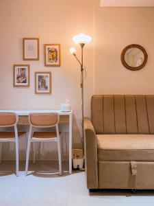 a living room with a couch and a table at Madison Park Apartment HOMEY by Host Jess in Jakarta