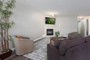 a living room with two couches and a fireplace at Paradise Canyon Golf Resort - Signature Walkout Condo 380 in Lethbridge