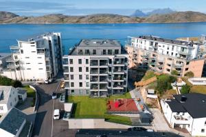 an aerial view of a city with a body of water at Modern Apartment near Airport in Bodø