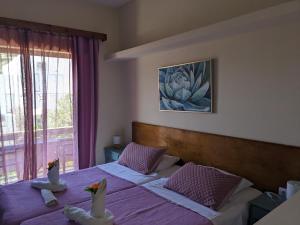 two beds in a room with two swans on them at Pension Irene in Sougia
