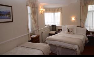 Postel nebo postele na pokoji v ubytování Windermere Lynwood Guest House