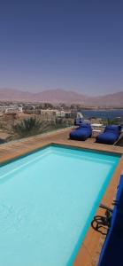 a swimming pool with a view of the desert at THE white lotus in Eilat