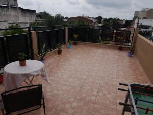 a balcony with a table and a pool table at Lo de Moni in San Ramón de la Nueva Orán +2 photos