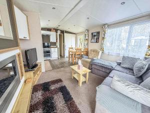 a living room with a couch and a table at Brilliant Caravan With A Partial Sea View In Suffolk Ref 32026Az in Lowestoft