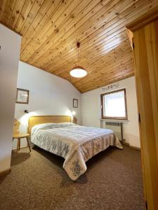 Postel nebo postele na pokoji v ubytování Simi Dolomiti