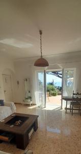a living room with a bed and a table at Villetta Rosetta in Capri