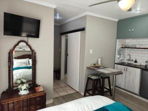 a bedroom with a bed and a kitchen with a sink at Sweet Dreams - Bethlehem in Bethlehem