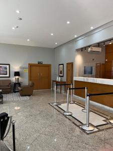 a large room with a lobby with a couch and a table at Flat em frente ao Allianz Parque in Sao Paulo +16 photos