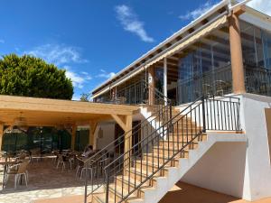 an external view of a building with stairs and tables at Apartamento María Isabel en Los Collados Golf - Aguilas in Águilas