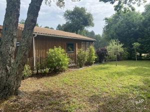 ein Blockhaus mit einem Zaun im Hof in der Unterkunft Chalet VIP Ostéa au coeur du Bassin d'Arcachon in La Teste-de-Buch