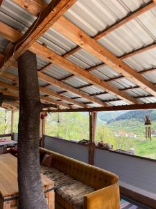 a living room with a large window with a tree at NINO Natural wood house in Visoko