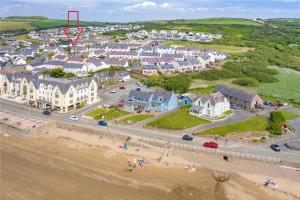 an aerial view of a town with a beach and houses at Family friendly house 200 meters to beach in Broad Haven