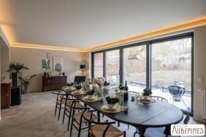 a large dining room with a table and chairs at Villa Aubépines in Rochefort