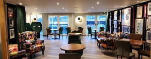 a restaurant with chairs and tables and windows at Pinnacle Suites Hotel in Cowes