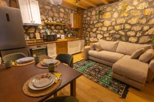 a living room with a couch and a table at Arhetip, Djedova Villa in Žabljak +19 photos