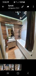 a bathroom with a tub and a sink and a mirror at Комфорт и уют in Lunacharskiy Bekati +37 photos