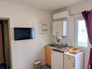 a small kitchen with a sink and a stove at Sunset Dreams Utjeha in Utjeha