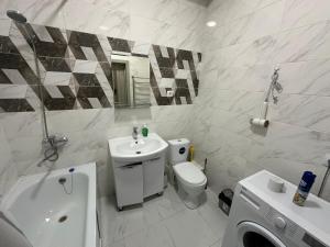 a white bathroom with a sink and a toilet at Etno Naz in Bishkek +17 photos