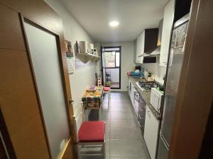 a small kitchen with a table and a counter top at Piso cercano al puerto in Denia