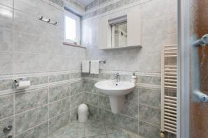 a bathroom with a sink and a toilet in it at Apartments Obradović in Neum +41 photos