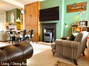 a living room with a couch and a table at BillWatch Cottage in Southwell