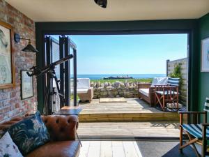 a living room with a view of the ocean at BillWatch Cottage in Southwell