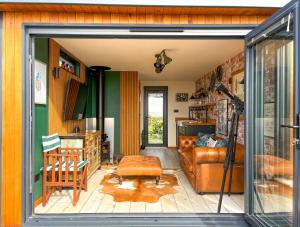 a living room with a couch and a chair at BillWatch Cottage in Southwell