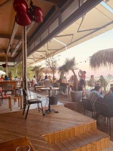 a group of people sitting at tables in a restaurant at Sea Garden Marina 3 in Varna City