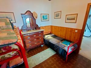 a bedroom with a dresser and a mirror at Villa dell'Ancora in Capoliveri