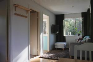 an open door to a living room with a television at Hummelviks stugan in Eckerö