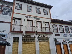 a white building with a bunch of doors and windows at Sollar da Chica in Diamantina