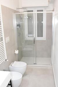 a white bathroom with a shower and a toilet at SWEET RETREAT - Trastevere Station in Rome