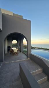 an external view of a house with a swimming pool at Serenity Getaway in Ierapetra