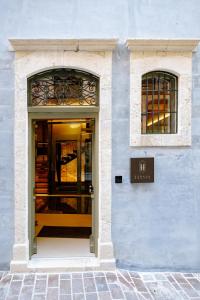 a door to a building with a sign above it at Elysia Boutique Hotel in Chania Town